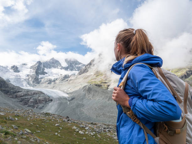 istock Young woman hiking towards glacier 1257937038