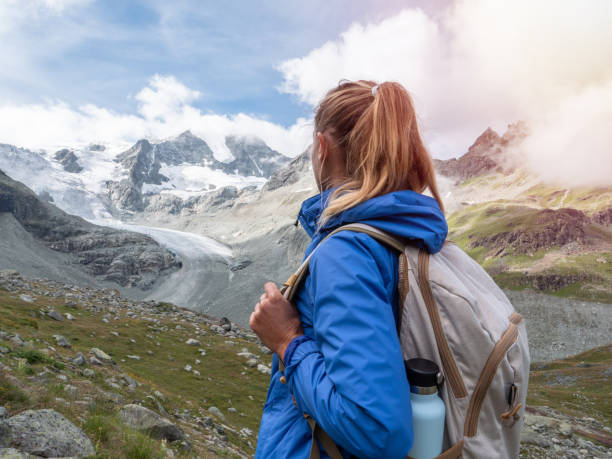 istock Young woman hiking towards glacier 1257938212