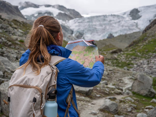 istock Hiker looking at trail map and directional signs 1257938964