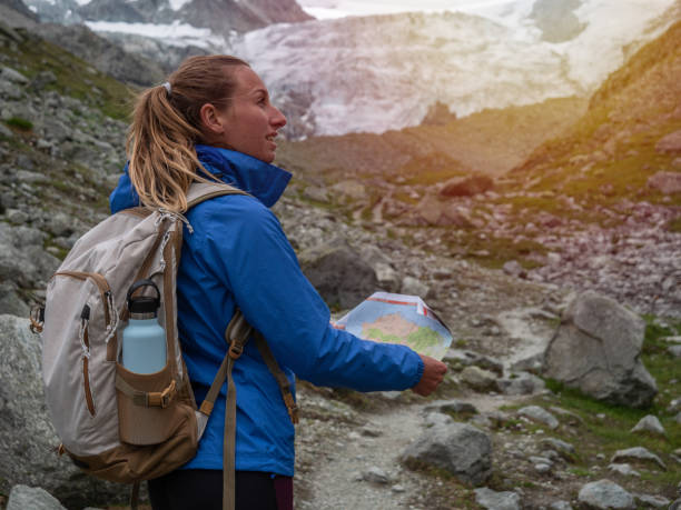 istock Hiker looking at trail map and directional signs 1257938966