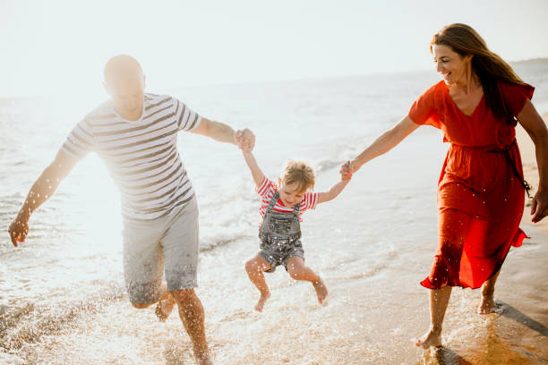 istock Family enjoys the sunset on the beach 1257939139