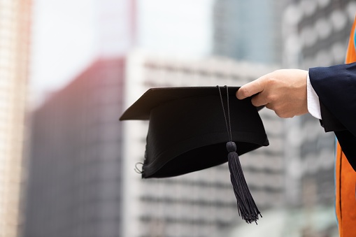 A photograph of a man with a hat after graduation