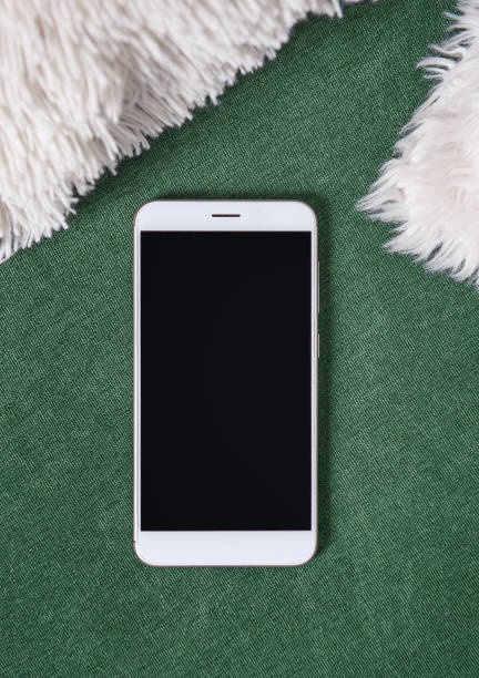 istock Top view with smartphone on fabric background. Mock up for design 1257942418