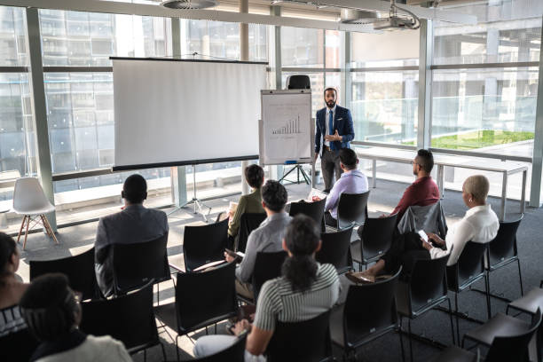 Business people attending a seminar with social distancing