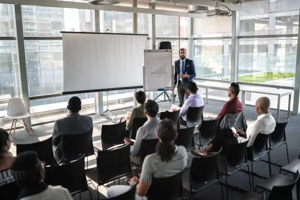 Business people attending a seminar with social distancing