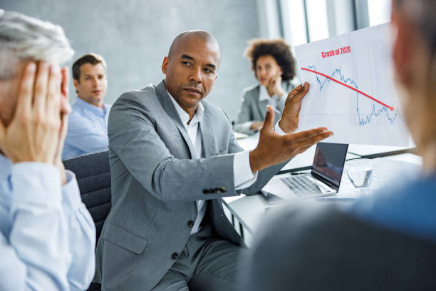 istock Black businessman analyzing economic crash with his colleagues in the office. 1257944878