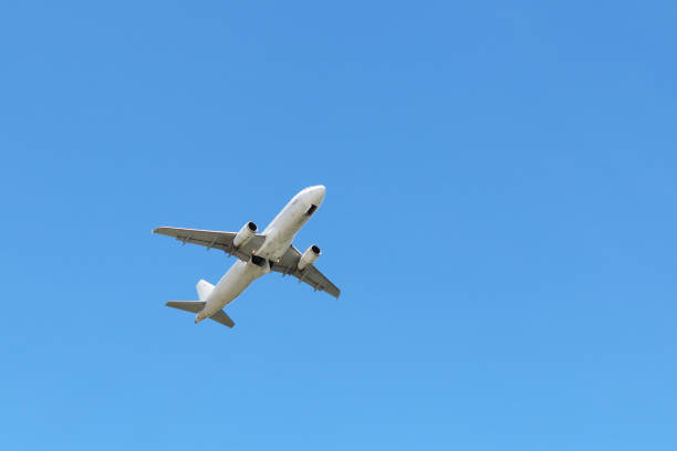 istock Airplane flying in the clear blue sky, bottom view 1257945832