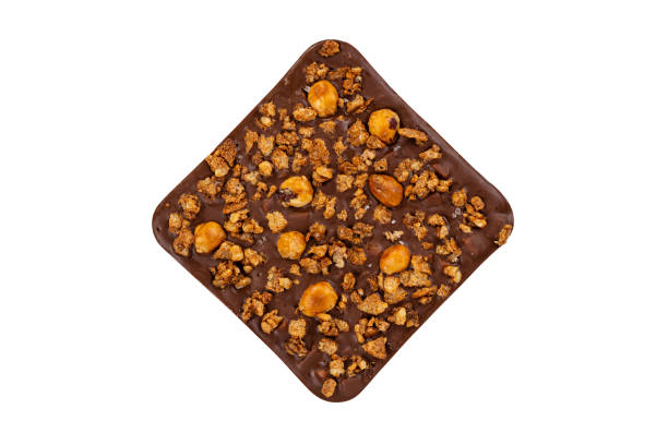 istock Milk chocolate bar with nuts isolated on white background. Luxury handmade chocolate with praline 1257946191