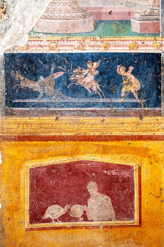 Winged cupids fight, little gods of ancient Rome in Pompeii. Pompeii was destroyed by the volcanic eruption of Vesuvius in 79 BC
