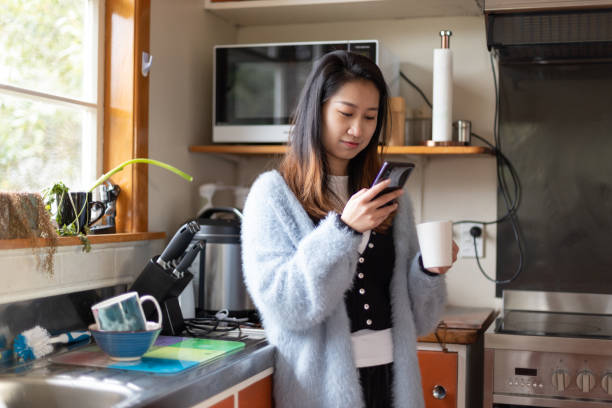 istock young asian woman using laptop and making phone call working at home during COVID-19 1257947049