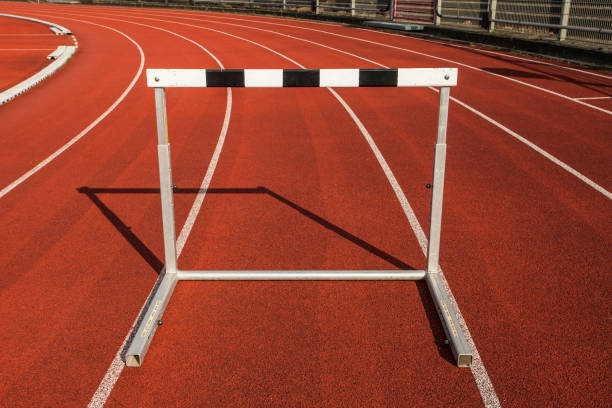 istock hurdle race barrier on stadium track 1257947367