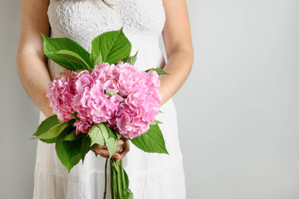 Free Stock Photo of Woman in Wedding Dress Holding Bouquet of Flowers ...
