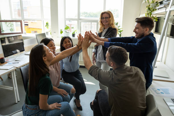 istock Multiracial employees team with male leader, coach giving high five. 1257948522