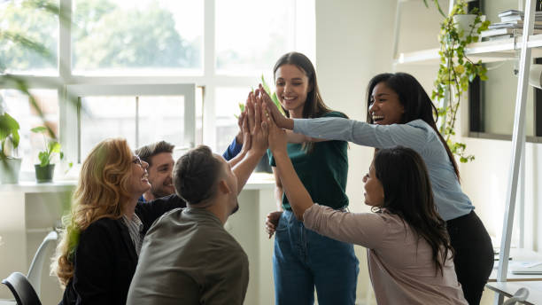istock Funny diverse workers with happy female leader giving high five. 1257948534