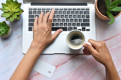 Hands using laptop for online shopping