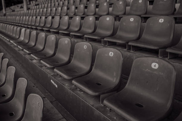 empty seats in a sports stadium black and white empty seats in a sports stadium, no fans, no people, black and white photo black and white bench stock pictures, royalty-free photos & images