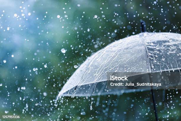 Transparent Umbrella Under Rain Against Water Drops Splash Background Rainy Weather Concept Stock Photo - Download Image Now