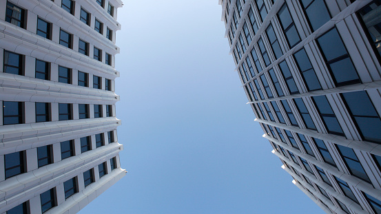 Modern buildings from low angle view against blue sky. Commercial office buildings exterior