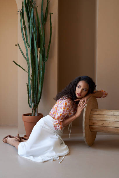 istock a girlposing on floor near cactus. 1257954889