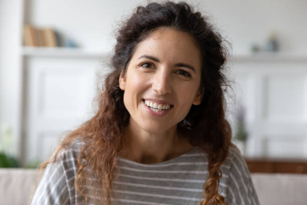 istock Head shot portrait smiling woman speaking, looking at camera 1257955498