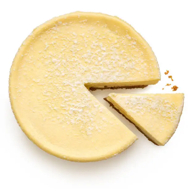 New York style cheesecake with a slice cut out isolated on white. Top view.