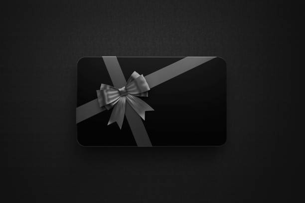 istock Black Gift Card with Black Tied Bow Sitting over Black Background 1257961411