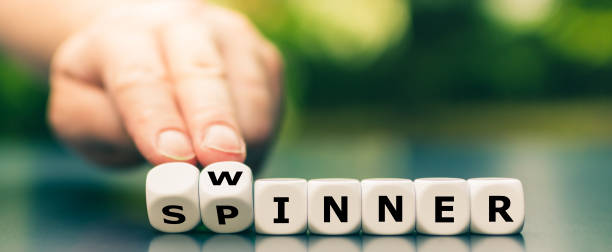 istock Hand turns dice and changes the word spinner to winner. 1257962494
