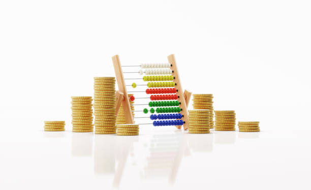 Abacus sitting amongst coin stacks over white background. Horizontal composition with clipping path and copy space. Savings concept.