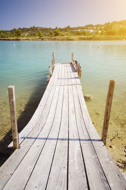 istock Wooden deck leading into sea marine 1257963931