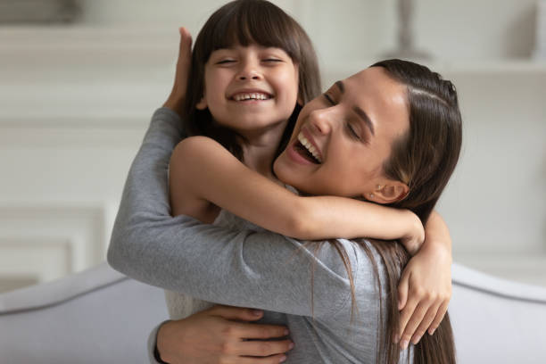 istock Happy young mom and little daughter hugging 1257964388