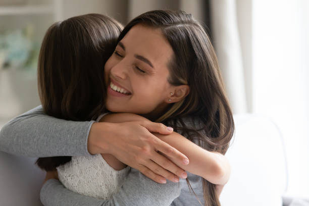 istock Smiling young mother and little daughter hug making peace 1257964405