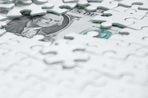 Missing jigsaw puzzle pieces on money dollar background, Business solution concept ,key for success