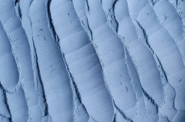 istock Light blue bentonite facial clay powder (alginate mask, body wrap) texture close up, selective focus. Abstract background with brush strokes. 1257965177