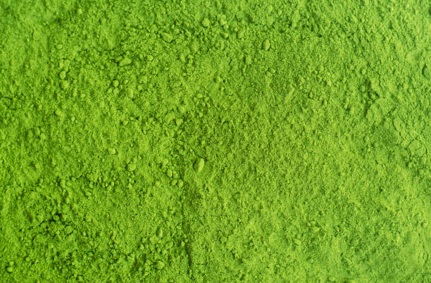 Matcha powder background. Green tea texture close-up, selective focus