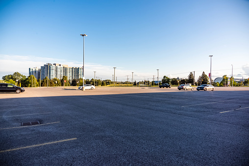 The parking lot at the Whitby Go station empty while cars are parked. This is empty due to Covid-19 and time of day