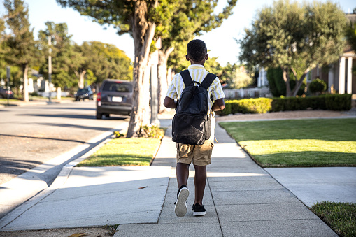 Young little boy walks to school in the morning in Santa Monica, California.