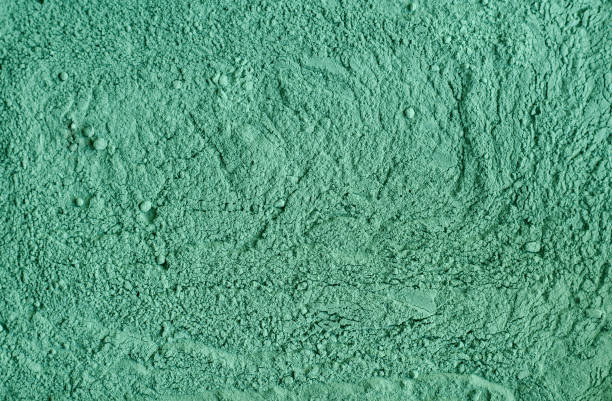 istock Green cosmetic clay powder (kelp facial mask, spirulina body wrap) texture close up, selective focus. Abstract background. 1257965716