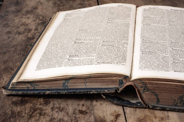 istock Old book lies on a wooden background 1257965753