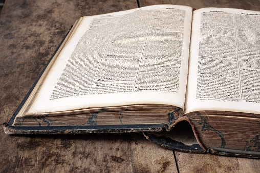 Old book dictionary on a wooden background