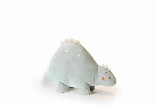 istock Soft light green Stegosaurus dinosaur plushie toy isolated on white background with shadow reflection. The concept of gifts for the holidays. Toy in the shape of an animal. Side wiew 1257967700