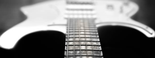 istock White electric guitar. Music concept. Creative style with light shadows. 1257967910