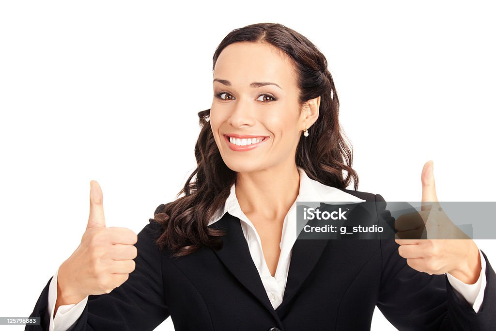 Brunette woman posing with thumbs up on white background Happy smiling business woman showing thumbs up gesture, isolated on white background Adult Stock Photo