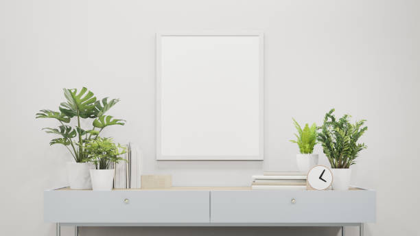 istock Plant in flower pot near empty picture frame. 1257969344