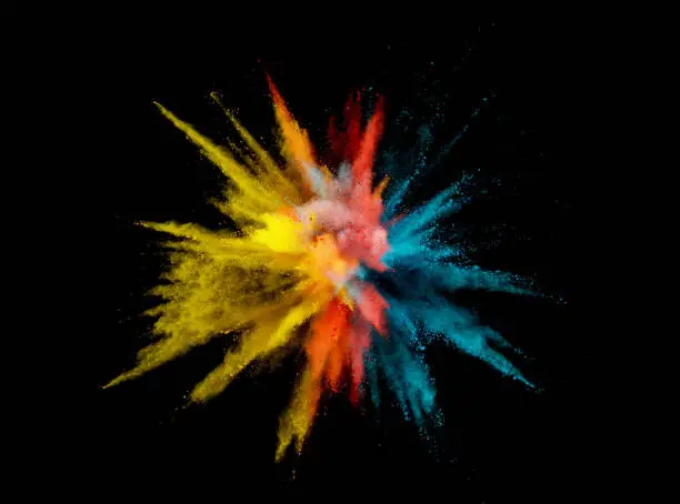 Photo of Abstract coloured powder explosion on black