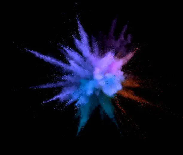 Abstract coloured powder explosion on black background