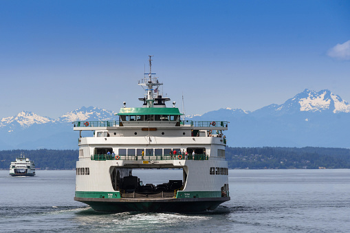 Seattle, Washington State, USA - June 2018: Large passenger and car ferry leaving Seattle to cross Puget Sound. A network of car ferries connect the city with the surrounding islands