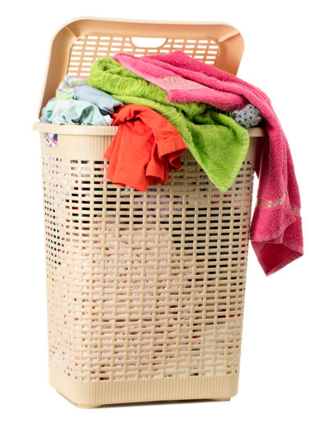 istock Laundry basket full of dirty washing (isolated on white) 1257970722