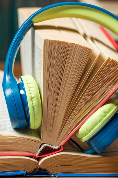 istock Audio book concept - headphones with books 1257971454