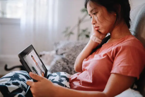 Photo of Woman having an online telemedicine discussion with her doctor