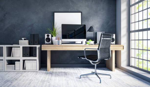 Modern home office interior Interior of a modern home office next to a big window. Light wood desk with organized set up of books, office supplies and computer with some room decor around it. small office interior stock pictures, royalty-free photos & images